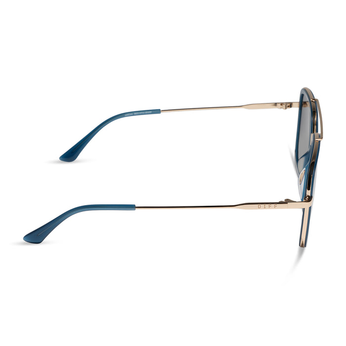diff eyewear featuring the jordan navigator sunglasses with a clubhouse blue frame and gold metal with grey gradient polarized lenses side view