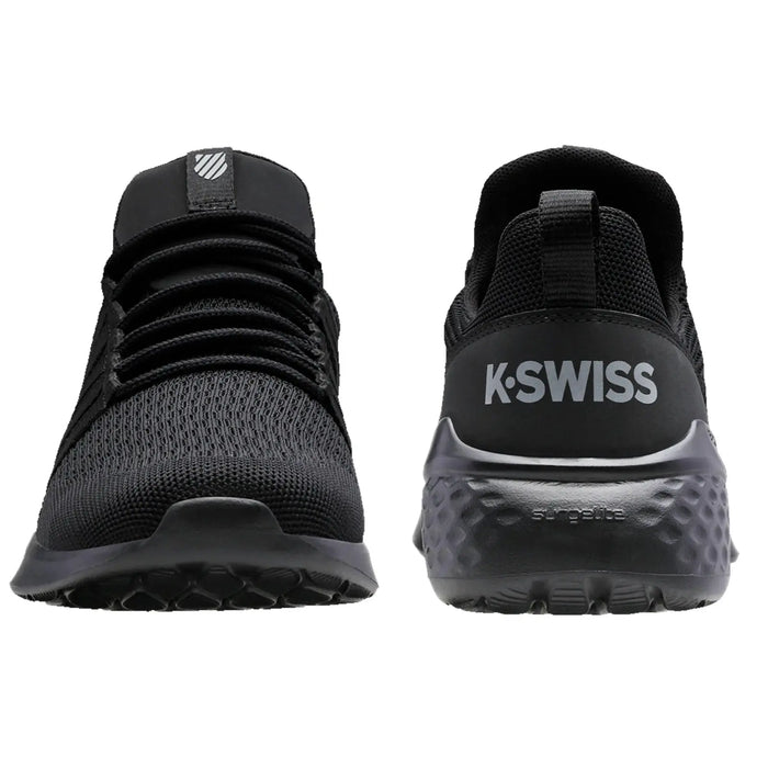 Black athletic shoes are displayed upright showcasing a mesh upper and rubber sole with a textured pattern K-Swiss branding is visible on the heel in contrasting white.