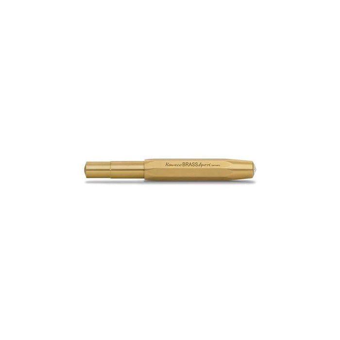 Closed brass fountain pen on white background