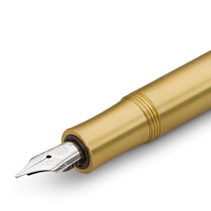 Gold fountain pen on a white background
