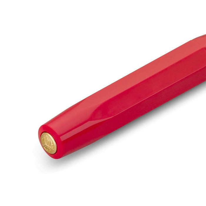 Red pen cap with gold accent on white background