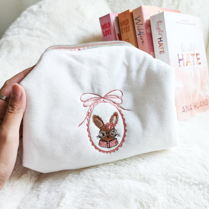 Little Rabbit and Her Book Zippered Pouch | Bookish Makeup & Reading Accessories Bag - The Bean Workshop - book girlie, bookish gift, bookish pouch, bow, coquette, coquette aesthetic, embroidered pouch, gift for book lovers, kindle bag, makeup bag, quilted pouch, rabbit book bag, reading accessories, reading accessories bag, zipper pouch