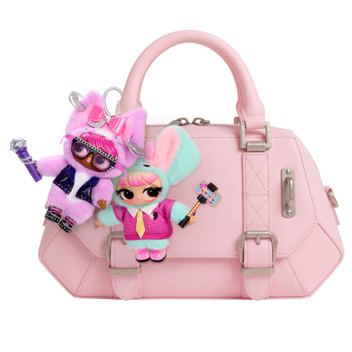 Pink handbag with character figurines attached on a white background