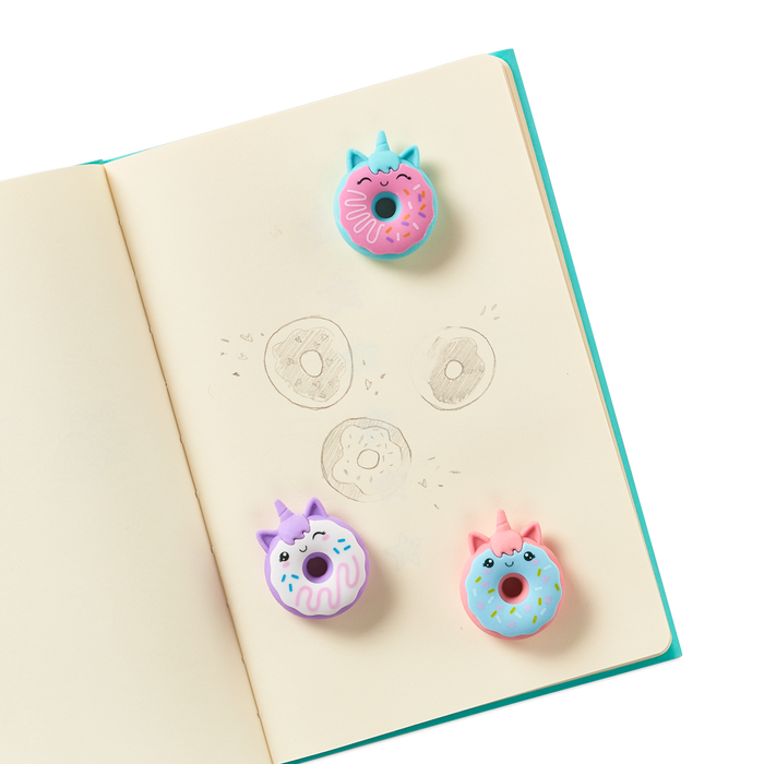 Magic Bakery Unicorn Donut Scented Erasers on a journal