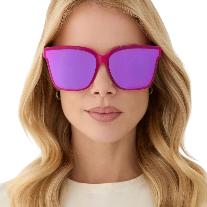 on model - blonde female wearing diff eyewear featuring the meredith ii square sunglasses with a bright pink tulip frame and pink mirror lenses front view