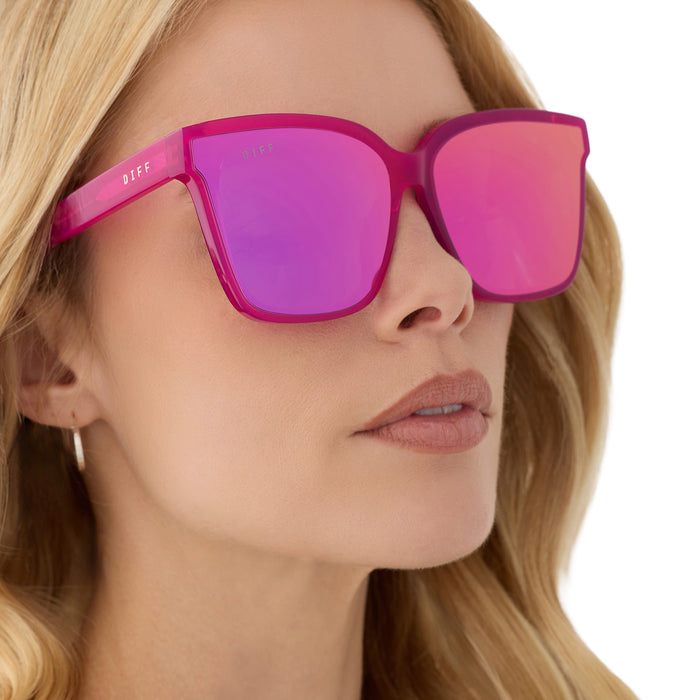 on model - blonde female wearing diff eyewear featuring the meredith ii square sunglasses with a bright pink tulip frame and pink mirror lenses detailed view