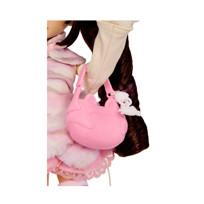 A pink cat-shaped handbag with a white charm, shown being carried by a doll wearing a pink and white outfit against a white background.