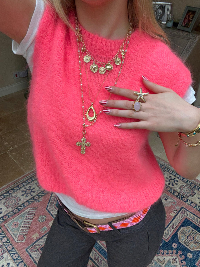 Layered gold necklaces styled for a cool jewellery stack