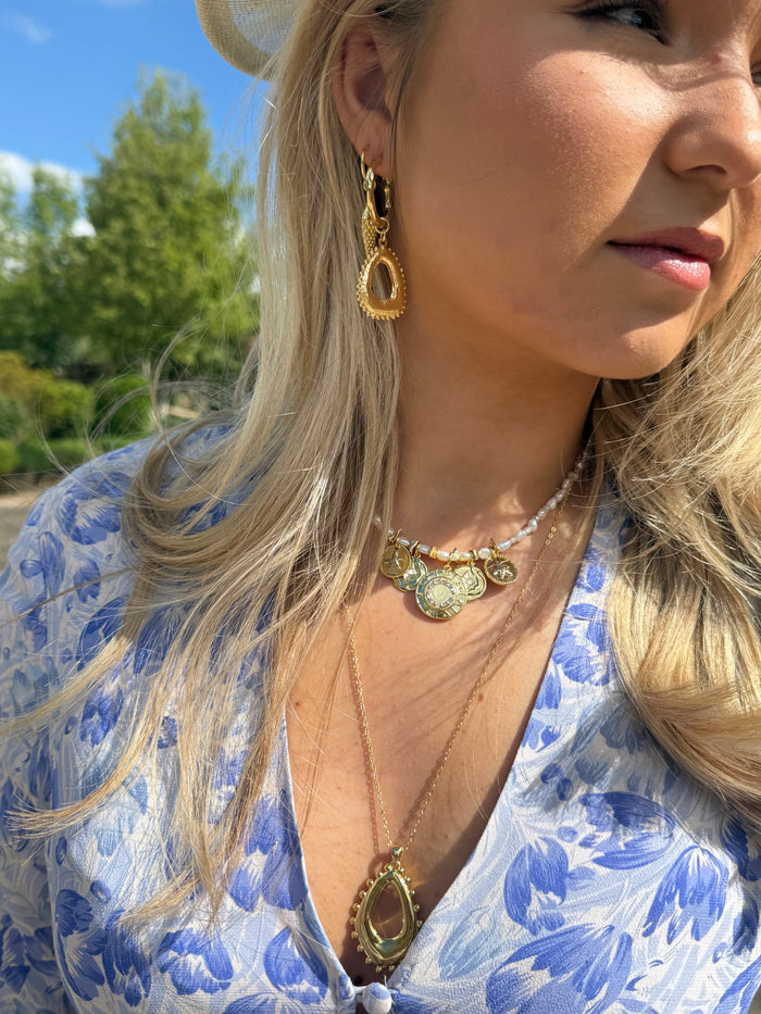 Summer jewellery stack with chunky gold necklaces
