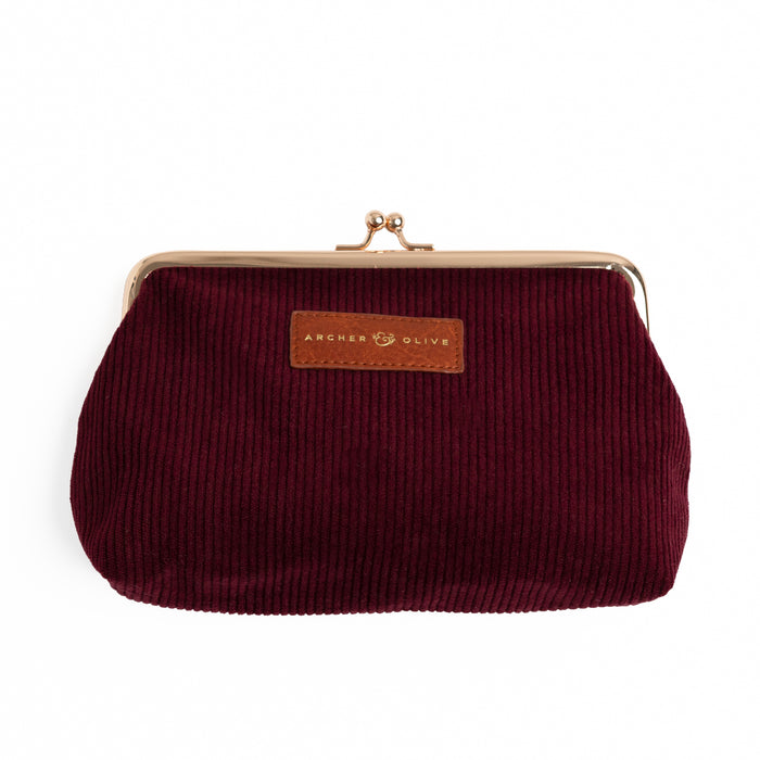 Maroon corduroy kiss-lock pouch with rose-gold frame and leather brand patch