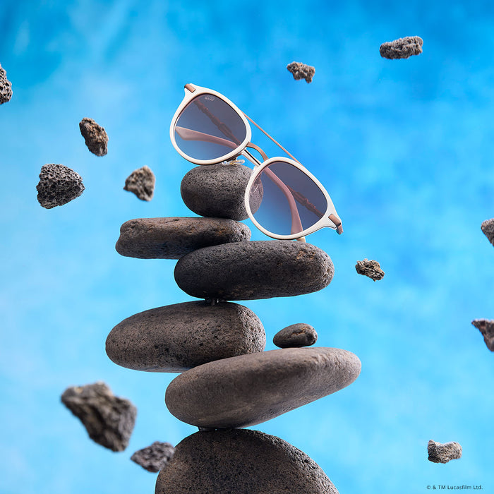 lifestyle - floating with rocks star wars x diff eyewear featuring the rey™ round sunglasses with a off white + bronze frame and brown gradient polarized lenses front view