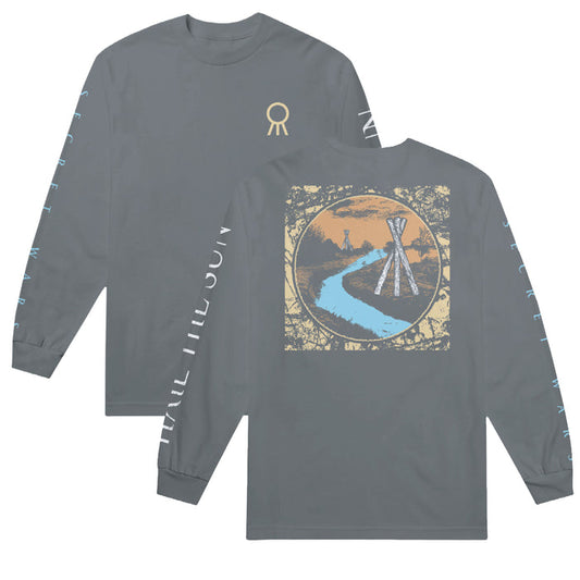 Hail The Sun gray long-sleeve T-shirt featuring a small gold symbol on the chest, blue Hail The Sun text along the sleeves, and a large circular back graphic showing a river, tepees, and sunset.