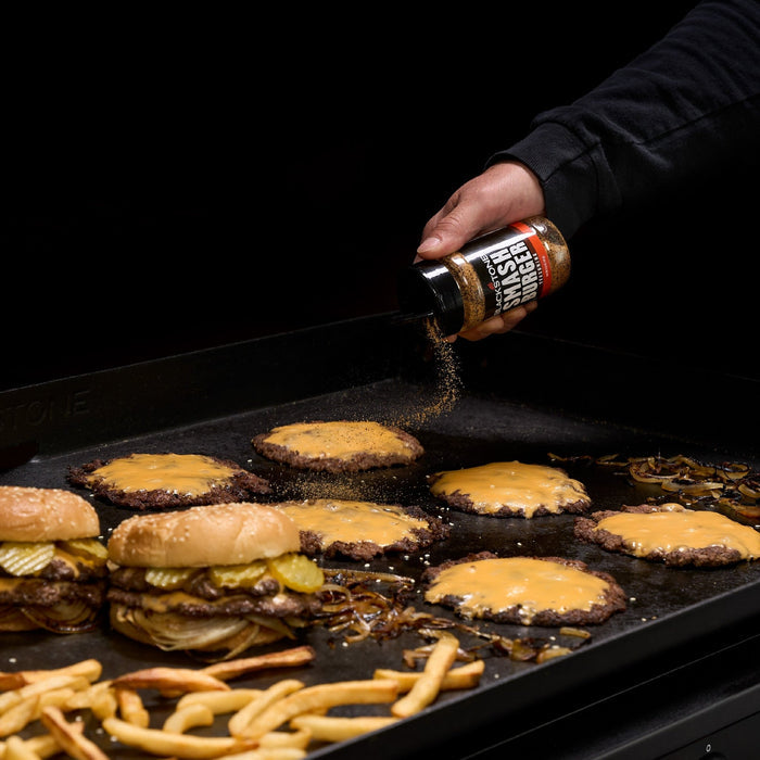 Smash Burger Seasoning put on smash burgers on a griddle.