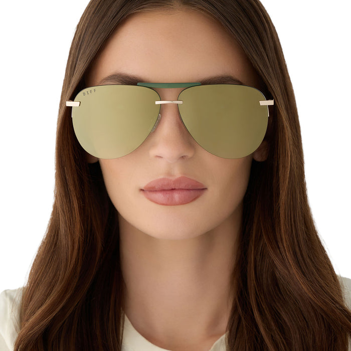 on model - female wearing diff eyewear featuring the tahoe aviator sunglasses with a gold metal and green accent frame with a aloe green gradient and light gold flash polarized sunglasses front view