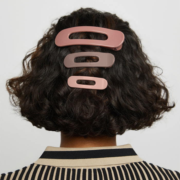 Model wearing Terracotta Flat Claw Clips in short curly hair against a light gray background
