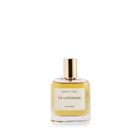 A glass bottle of perfume/cologne by Boyd's of Texas filled with a golden liquid fragrance topped with a polished brass cap