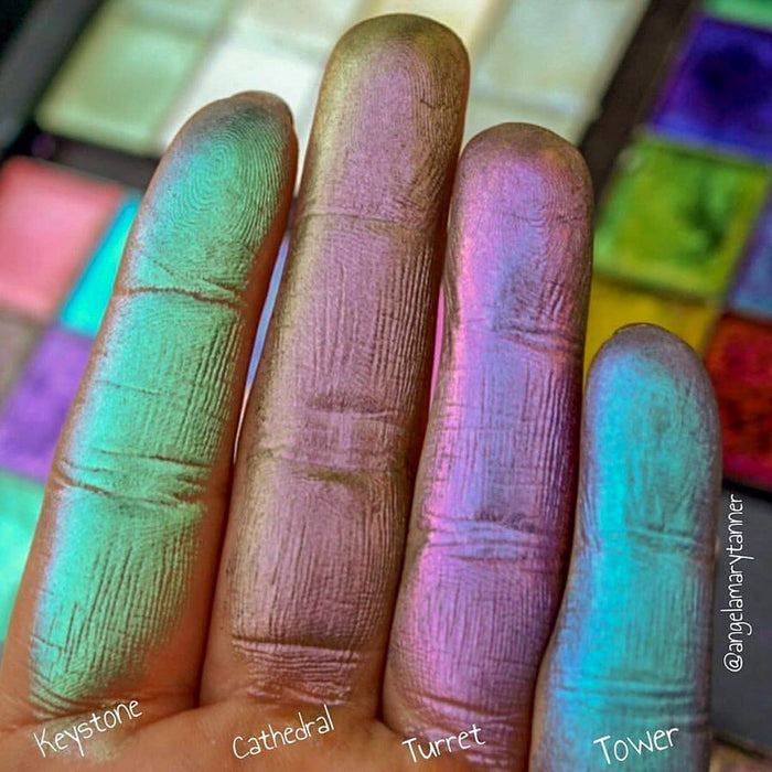 Close up finger swatches of Turret Pastel Multichrome Eyeshadow shifts next to Tower, Keystone, Cathedral