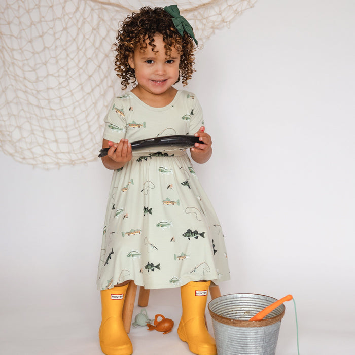 Girl wearing Kyte Baby Twirl Dress in Fishing