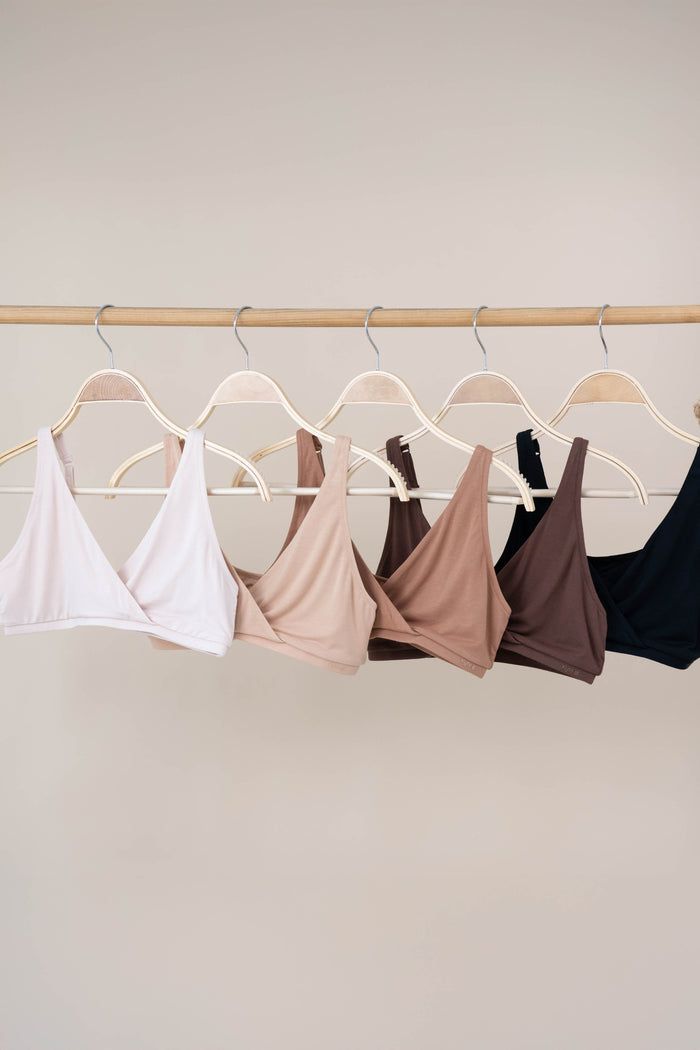 Women's Cross Front Bralette's in neutrals hanging on hangers
