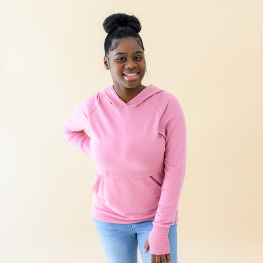 Woman wearing Kyte Baby Women's French Terry Nursing Hoodie in Apple Blossom