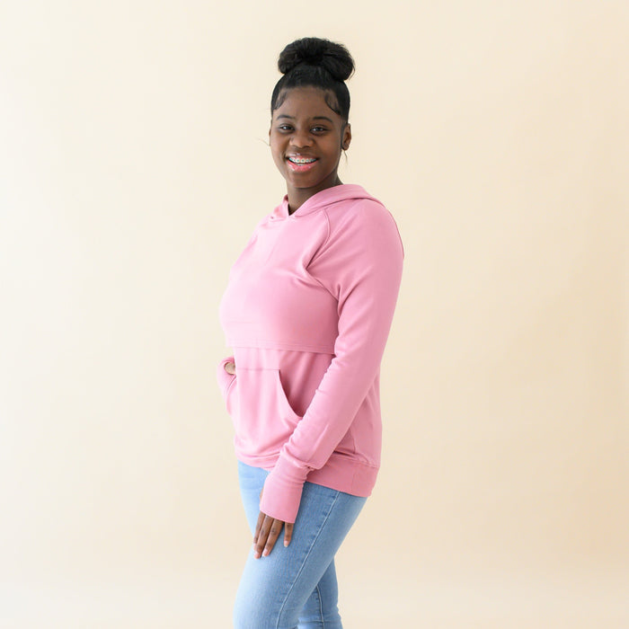 Woman wearing Kyte Baby Women's French Terry Bamboo Nursing Hoodie with Kangaroo Pocket in Apple Blossom
