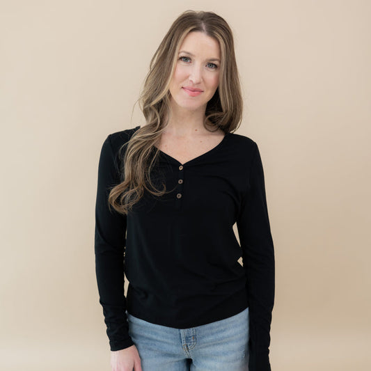 Woman wearing Kyte Baby Women's Long Sleeve Henley Tee in Midnight