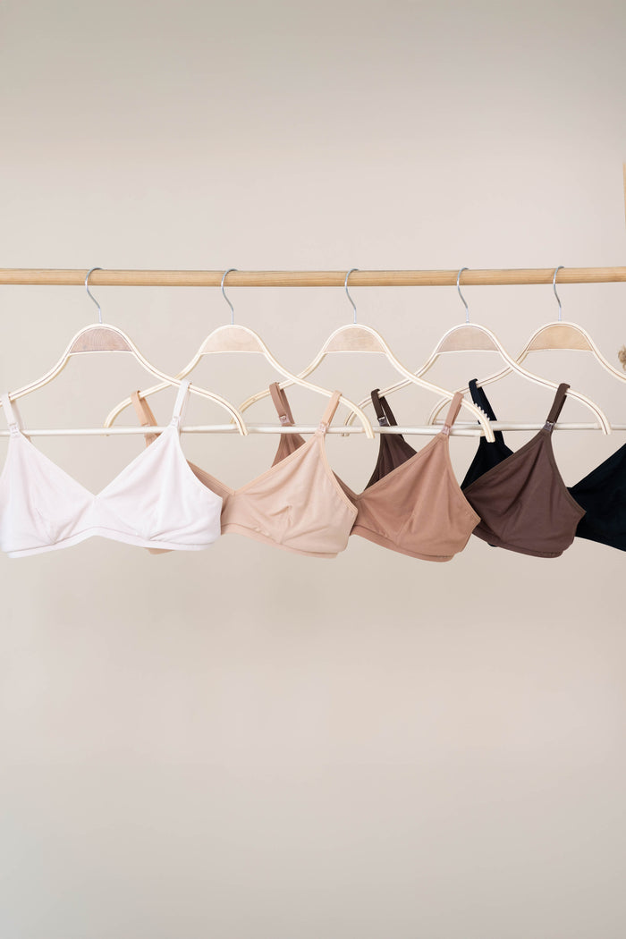 Women's Nursing Bra in neutral colors shown hanging on hangers
