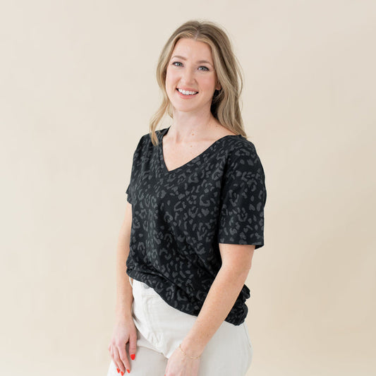 Woman wearing Kyte Baby Women's Relaxed Fit V-Neck in Midnight Leopard