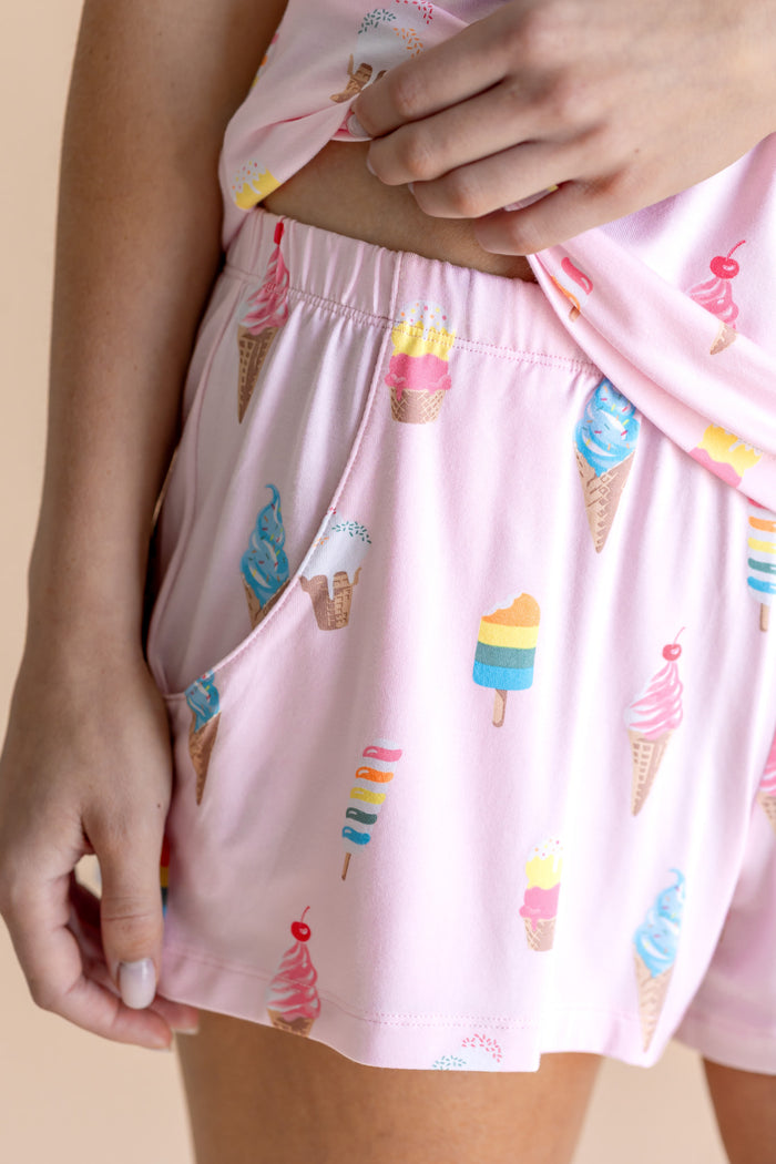 Model showcasing the Women's Tank Set Shorts in Sakura Ice Cream print on beige background