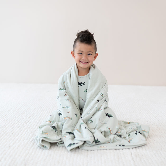 Sitting Toddler in Fishing Pajamas wrapped in Youth Blanket in Fishing 2.5