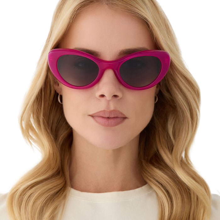 on model - female wearing diff eyewear featuring the zaria cat eye sunglasses with a bright tulip pink frame and grey gradient polarized lenses front view